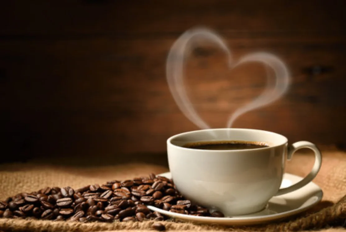 A cup of Greenlove coffee with heart-shaped steam