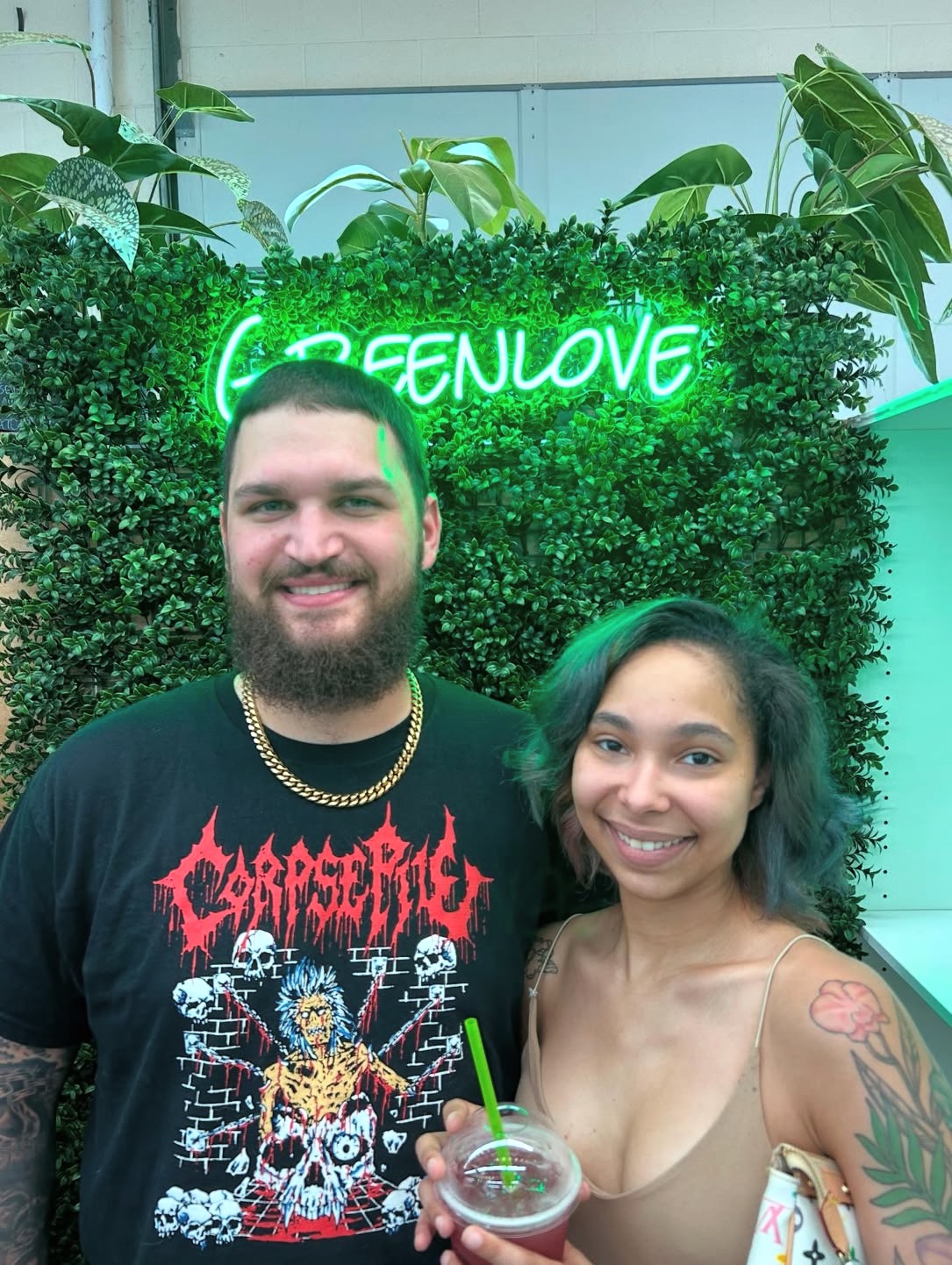 Friends at the Greenlove neon sign