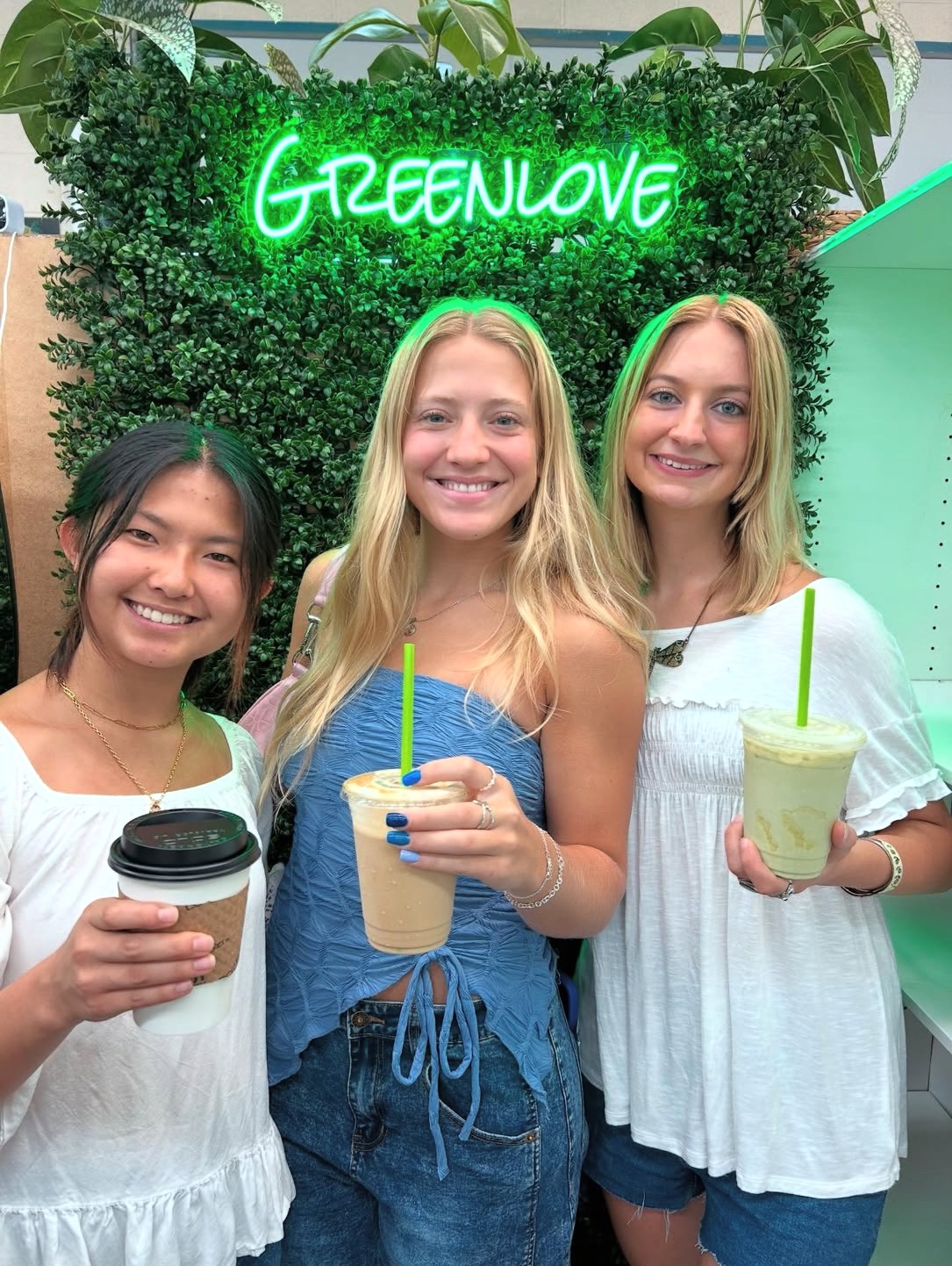Three friends with Greenlove drinks